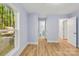 Spacious bedroom showcasing blue walls, wood-look flooring, and access to the bathroom at 5414 Leaford Ct, Charlotte, NC 28227