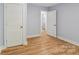 Spacious room featuring fresh blue paint, luxury vinyl flooring, and white painted trim at 5414 Leaford Ct, Charlotte, NC 28227