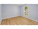 Bedroom featuring luxury vinyl flooring, blue walls, and a new window at 5414 Leaford Ct, Charlotte, NC 28227