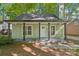Charming home with a covered porch, black support beams, and verdant landscaping at 5414 Leaford Ct, Charlotte, NC 28227