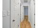 Hallway showcasing fresh blue paint, modern lighting fixtures, and wood-look flooring at 5414 Leaford Ct, Charlotte, NC 28227