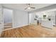 Open floor plan shows the stairs, kitchen with white cabinets, and hardwood floors at 5414 Leaford Ct, Charlotte, NC 28227