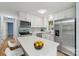 Modern kitchen with stainless steel appliances, white cabinets, and quartz countertops at 5414 Leaford Ct, Charlotte, NC 28227
