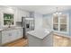 Bright kitchen featuring stainless steel appliances, white cabinets, and a center island with white countertop at 5414 Leaford Ct, Charlotte, NC 28227