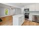 Bright kitchen includes an island, white cabinets, and stainless steel appliances at 5414 Leaford Ct, Charlotte, NC 28227