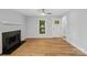 Cozy living room with fireplace, light blue walls, hardwood floors, and bright windows at 5414 Leaford Ct, Charlotte, NC 28227