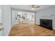 Open concept: Living room view showing fireplace and modern kitchen with island at 5414 Leaford Ct, Charlotte, NC 28227