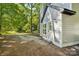 Backyard view featuring light gray siding, clean white trim, a quaint outdoor space, and a lush lawn at 5414 Leaford Ct, Charlotte, NC 28227