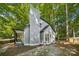 Image showcases a modern chimney design with light gray siding, complemented by lush green trees at 5414 Leaford Ct, Charlotte, NC 28227