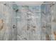 Walk-in shower showcasing blue onyx tile, a built-in niche, and modern fixtures at 5414 Leaford Ct, Charlotte, NC 28227