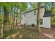 Features a two-story home with light gray siding surrounded by a wooded lot, offering privacy at 5414 Leaford Ct, Charlotte, NC 28227