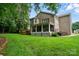 Expansive backyard with a deck, covered porch, and well-manicured lawn, perfect for entertaining at 6324 Old Fox Hunt Ln, Mint Hill, NC 28227