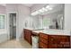 Bathroom showcasing double vanities, a large mirror, and tile flooring at 6324 Old Fox Hunt Ln, Mint Hill, NC 28227