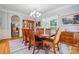 Formal dining room with hardwood floors, chandelier, and view into the adjacent kitchen at 6324 Old Fox Hunt Ln, Mint Hill, NC 28227