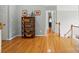 Spacious hallway with hardwood floors, decorative shelving, and an open doorway at 6324 Old Fox Hunt Ln, Mint Hill, NC 28227