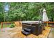 Outdoor hot tub nestled on a wooden deck surrounded by lush greenery, offering a serene retreat at 6324 Old Fox Hunt Ln, Mint Hill, NC 28227