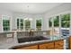 Kitchen features a granite countertop island, stainless sink, and windows overlooking the backyard at 6324 Old Fox Hunt Ln, Mint Hill, NC 28227