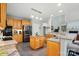 Open concept kitchen featuring granite countertops, stainless steel appliances, and tiled floors at 6324 Old Fox Hunt Ln, Mint Hill, NC 28227