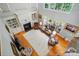 Aerial view of a living room with a fireplace, built-in shelving and hardwood floors at 6324 Old Fox Hunt Ln, Mint Hill, NC 28227