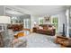 Open-concept living room and dining room with hardwood floors, natural light, and neutral decor at 6324 Old Fox Hunt Ln, Mint Hill, NC 28227