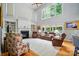 Bright living room featuring a grand fireplace, large windows, and hardwood floors at 6324 Old Fox Hunt Ln, Mint Hill, NC 28227