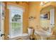 Stylish powder room with decorative mirror, sconces, and a pedestal sink at 6324 Old Fox Hunt Ln, Mint Hill, NC 28227