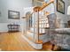 Elegant staircase featuring wooden handrails, white spindles and hardwood flooring at 6324 Old Fox Hunt Ln, Mint Hill, NC 28227