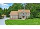 Charming brick home with a well-manicured lawn and inviting front porch with rocking chairs at 6324 Old Fox Hunt Ln, Mint Hill, NC 28227
