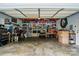 Functional garage space equipped with ample shelving, a workbench, and tool storage at 6324 Old Fox Hunt Ln, Mint Hill, NC 28227