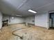 Unfinished basement with concrete floors, white walls, and a utility door at 643 Baron Rd # 8, Waxhaw, NC 28173