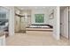 Bright bathroom with a soaking tub, walk-in shower, and neutral tiling at 643 Baron Rd # 8, Waxhaw, NC 28173