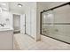 Bathroom featuring tiled floors, cabinet space and a glass-enclosed shower at 643 Baron Rd # 8, Waxhaw, NC 28173