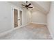 Bright bedroom with a ceiling fan, double doors, neutral carpet, and crisp white trim at 643 Baron Rd # 8, Waxhaw, NC 28173