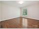 Bedroom showcasing hardwood floors and natural light from a large window at 643 Baron Rd # 8, Waxhaw, NC 28173