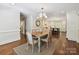 Dining room with natural light, hardwood floors, and an adjacent kitchen at 643 Baron Rd # 8, Waxhaw, NC 28173