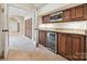 Hallway bar area featuring custom cabinetry, a beverage fridge, and granite countertops at 643 Baron Rd # 8, Waxhaw, NC 28173