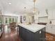 Bright, open kitchen with large island, modern lighting, stainless appliances and hardwood floors at 643 Baron Rd # 8, Waxhaw, NC 28173