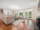 Bright and spacious living room features hardwood floors, comfortable seating, and a cozy fireplace at 643 Baron Rd # 8, Waxhaw, NC 28173