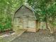Weathered wood outbuilding with double doors and a ramp, nestled among trees and foliage at 643 Baron Rd # 8, Waxhaw, NC 28173
