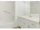 Bright bathroom featuring a shower-tub combo, vanity with cabinet storage, and sleek, neutral-toned finishes at 6817 Dumbarton Dr, Charlotte, NC 28210