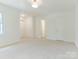 Large bedroom featuring plush carpet, multiple closets, and windows for lots of light at 6817 Dumbarton Dr, Charlotte, NC 28210