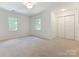 Neutral bedroom with plush carpet, dual windows, and a spacious closet at 6817 Dumbarton Dr, Charlotte, NC 28210