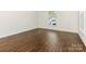 Bright bedroom features hardwood floors, a window with natural light, and fresh, white walls at 6817 Dumbarton Dr, Charlotte, NC 28210