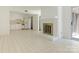 Open living space featuring tiled floors, a brick fireplace, and adjoins the kitchen at 6817 Dumbarton Dr, Charlotte, NC 28210