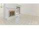 Bright living space featuring tiled floors, a brick fireplace, and natural light from a sliding door at 6817 Dumbarton Dr, Charlotte, NC 28210