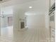 Open living space featuring tiled floors, a brick fireplace, and natural light from a sliding door at 6817 Dumbarton Dr, Charlotte, NC 28210