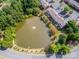 Aerial view of a scenic pond surrounded by colorful trees and landscaping at 6817 Dumbarton Dr, Charlotte, NC 28210