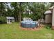 Private backyard featuring an above ground pool, a shed, and mature trees at 716 Mooresville Rd, Salisbury, NC 28144