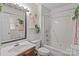 Bright bathroom with a tub/shower combination, decorative shelving, and a large mirror at 716 Mooresville Rd, Salisbury, NC 28144