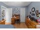 Bedroom with hardwood floors, desk, and decorative shelves, creating a cozy and functional space at 716 Mooresville Rd, Salisbury, NC 28144